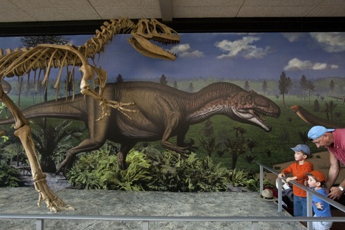 Chris Detrick  |  The Salt Lake Tribune
Marcel Radu, Phillip Radu, 5, and Martin Radu, 3, look at the allosaurus fossil during the Grand Opening Celebration of the Quarry Exhibit Hall at Dinosaur National Monument on Tuesday, Oct. 4, 2011. The old Quarry Exhibit Hall was closed in July 2006 due to safety hazards. The Carnegie Quarry contains nearly 1,500 fossils.  In addition to the fossil wall, the facility features exhibits about dinosaurs and other life from the Jurassic period.