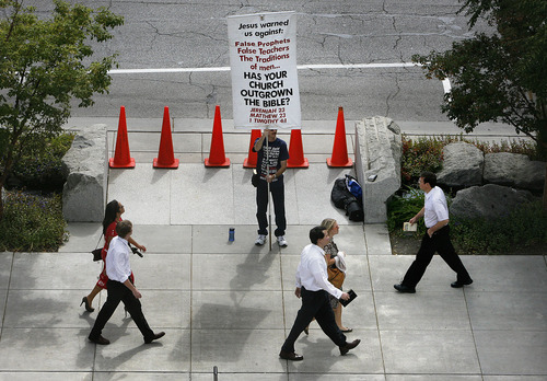 Scott Sommerdorf  |  The Salt Lake Tribune             
Those on their way to the afternoon session of the 181st Semiannual General Conference file past a man protesting the church, Sunday, October 2, 2011.