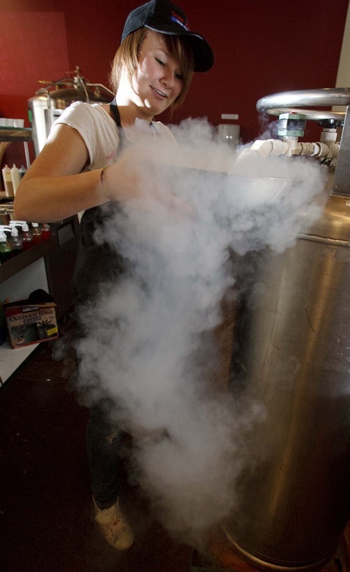 Trent Nelson  |  The Salt Lake Tribune
Marina Campbell is covered in fog as liquid nitrogen freezes cream and flavored ingredients into ice cream at Sub Zero Ice Cream in Centerville. Sub Zero Ice Cream is an American Fork-based business that is expanding into Davis County. Instead of serving up frozen ice cream, servers mix up the combination of creams, milks or yogurts a customer wants, then uses liquid nitrogen to freeze the mixture. , Saturday, December 5 2009 in Centerville.