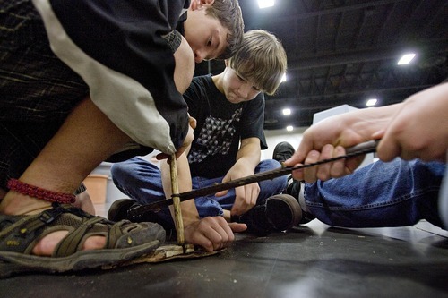 Djamila Grossman  |  The Salt Lake Tribune
Parker Keuma, 14, left, of Sandy, Ryan Chittock, 15, of Midvale and Bradley Goebel, 15, of Midvale try to create sparks for a fire at the Self Reliance Expo at the South Towne Expo Center in Sandy, Utah, on Saturday.
