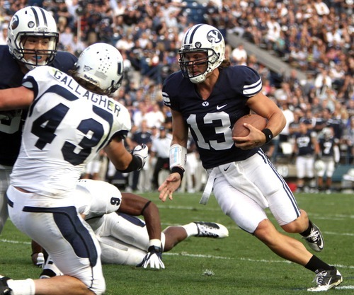 Rick Egan  | The Salt Lake Tribune 

Brigham Young Cougars quarterback Riley Nelson (13) runs for the end zone but comes up short, in football action, BYU vs Utah State,  in Provo, Friday, September 30, 2011.  Utah State Aggies linebacker Kyle Gallagher (43).