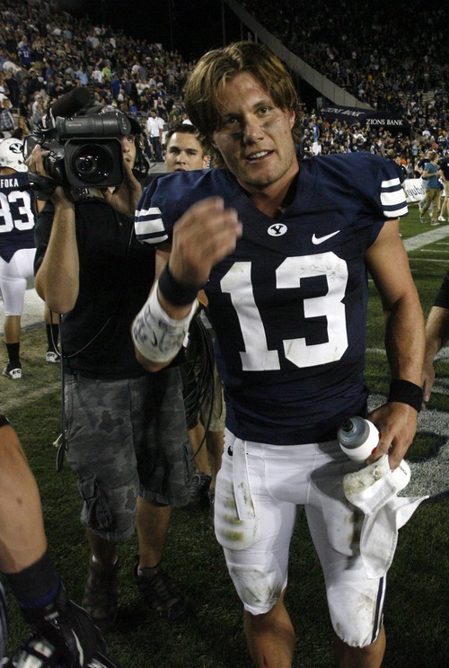Rick Egan  | The Salt Lake Tribune 
BYU quarterback Riley Nelson (13) smiles after the game as the Cougars celebrate their victory over Utah State, at Lavell Edwards stadium,  in Provo, Friday, Sept. 30, 2011.
