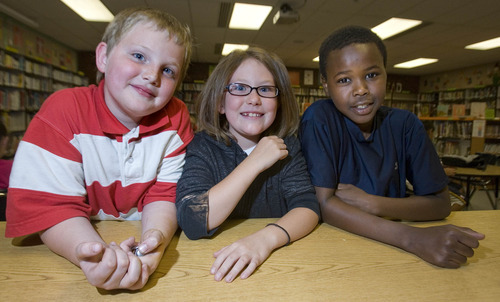 Paul Fraughton  |  The Salt Lake Tribune 
Tavien Lewis, Tara Gillespie and Nasser Albasis, youngsters attending the YMCA Fox Hills Afterschool Program, won awards in the Green Ideas for Taylorsville contest. Tara was the first-place winner. Tavien and Nasser were runners-up for their energy-saving ideas.