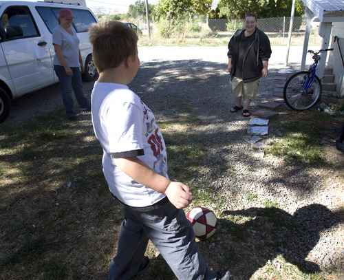 Steve Griffin  |  The Salt Lake Tribune
Eight-year-old Braxton Longman laughs as he plays soccer with his mother Michelle Longman, right, and grandmother Tracey Jones at their Bluffdale home in late September.