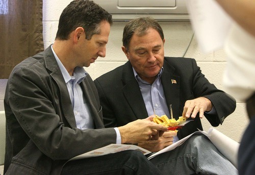 Leah Hogsten | The Salt Lake Tribune
Governor Gary Herbert (right) and chief of staff Derek Miller taste a sampling of cheeses after touring the Dairy Farmers of America plant. Utah Governor Gary Herbert met with Dairy Farmers of America in Beaver and other Beaver county and city leaders to discuss how to grow of jobs in the county Friday, October 14 2011.