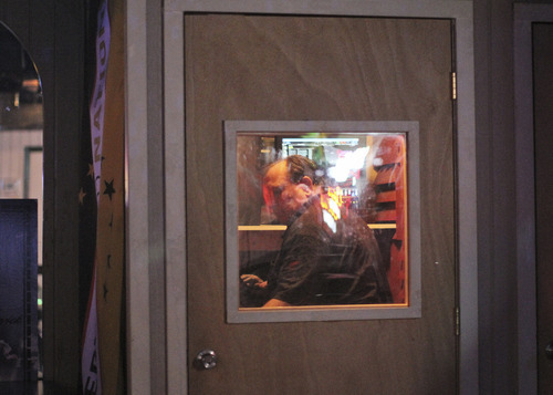 Lennie Mahler  |  The Salt Lake Tribune
A man at the Highlander Club karaoke bar chooses a song to practice in a sound-proof booth Friday, Aug. 26, 2011.