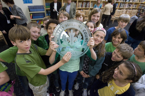 Paul Fraughton | The Salt Lake Tribune
Students at The McGillis School in Salt Lake City hold up a plaque Friday, Oct. 14, given to the school by the U.S. Green Building Council. The McGillis School was awarded a  Gold LEED certificate for its green building practices employed in the expansion of the school building.