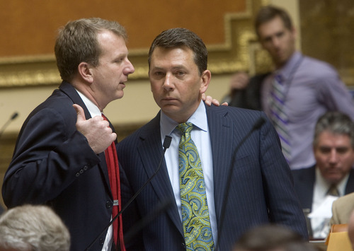 AL HARTMANN  |  The Salt Lake Tribune 
Rep. Stephen Sandstrom, R-Orem, right, takes time out during Friday's debate on his enforcement-only immigration bill to confer with Rep. Chris Herrod, R-Provo. The measure, after being amended for the second time in two weeks passed the House overwhelmingly, 58-15. It now goes to the Senate.