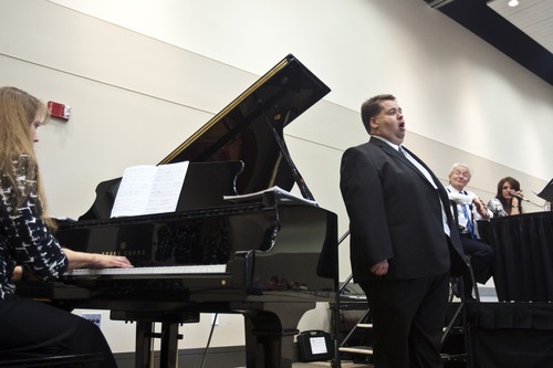 Chris Detrick  |  The Salt Lake Tribune
Mormon Tabernacle Choir member Laurent Neu sings at the 22nd Annual Families and Professionals Conference sponsored by the Brain Injury Association of Utah at the South Towne Expo Center on Thursday, Oct. 13, 2011.