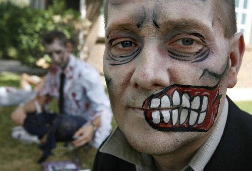 Scott Sommerdorf  |  The Salt Lake Tribune             
Matt Zundel poses for a photo with the makeup his wife applied to make him a zombie for the Night of the Running Dead race at the Utah Fairpark on Saturday. The race featured zombie runners chasing human runners after a two-minute head start for the humans.