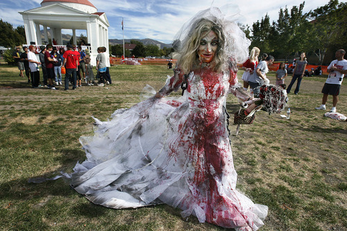 Scott Sommerdorf  |  The Salt Lake Tribune             
Jade Sarver of Cottonwood Heights walks around the Fairpark as an undead bride prior to the Night of the Running Dead on Saturday. The race featured zombie runners chasing human runners after a two-minute head start for the humans.