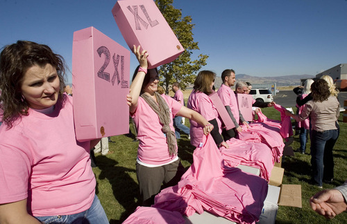 Paul Fraughton | The Salt Lake Tribune
GE Healthcare employees  are given pink T shirts as they prepare to form a human cancer awareness ribbon in a field next to their Salt Lake City  facilities.
  Wednesday, October 19, 2011