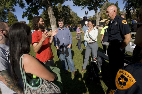 Al Hartmann  |  The Salt Lake Tribune
Salt Lake City Deputy Police Chief Mike Brown, right, listens to members of the Occupy SLC protesters camped in Pioneer Park in Salt Lake City on Thursday. One of the original organizers of the Salt Lake protest, Aharon Ben Or, speaks at left. Protesters and police praised each other for acting repsonsibly and maintaining a peaceful atmosphere in Pioneer Park.