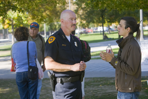 Al Hartmann  |  The Salt Lake Tribune
Salt Lake City Police Chief Chris Burbank talks with Jimmy Kosmas, right, a member of the outreach committee of the Occupy SLC on Thursday in Pioneer Park. Burbank stopped by Pioneer Park Thursday to help keep dialogue open with the protest group.
