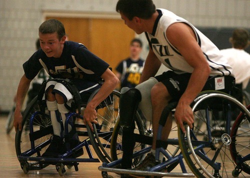 Leah Hogsten | The Salt Lake Tribune
Spencer Heslop, 17, rounds the defense of teammate Sam Blakley (left), and fellow members of the Wheelin' Jazz basketball team  Tuesday, Oct. 11 2011, at the Sorenson Multicultural Center. Heslop is a 17-year-old senior at Clearfield High School who just returned from the Netherlands where he participated in a paralympic camp.