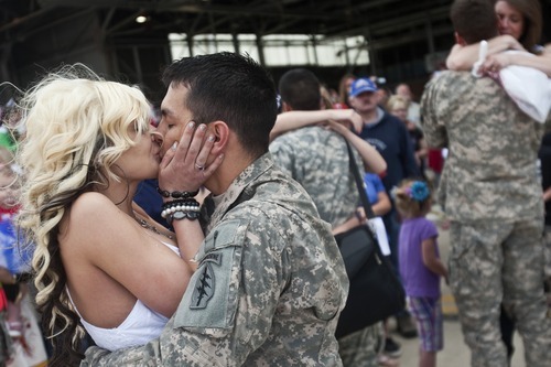 Chris Detrick | The Salt Lake Tribune 
Jessica Tingey kisses her husband, Sgt. Kendall Tingey, as he arrives at the Utah Air National Guard Base Saturday May 14, 2011.  About 100 Soldiers of the Utah National Guard's Group Support Company, 19th Special Forces Group (Airborne), returned to Utah from their 12-month deployment to Iraq.