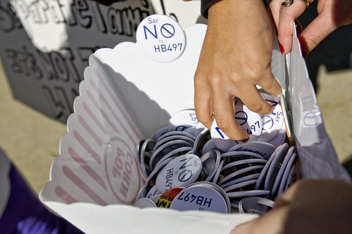 Djamila Grossman  |  The Salt Lake Tribune

People hand out buttons during a protest against the HB497 immigration bill at the City County Building in Salt Lake City, Utah, on Saturday, Sept. 22, 2011.