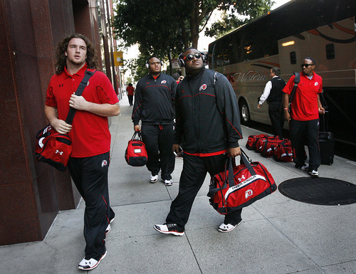 Scott Sommerdorf  |  The Salt Lake Tribune             
Utah OL John Cullen, left, and QB coach Brian Johnson and the rest of the team arrive at the team hotel in San Franciso on Friday.