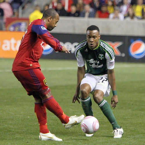 Stephen Holt/ Special to the Tribune
Real Salt Lake midfielder Andy Williams slides the ball past Portland Timbers' defender Rodney Wallace in the first half at Rio Tinto Stadium in Sandy.
