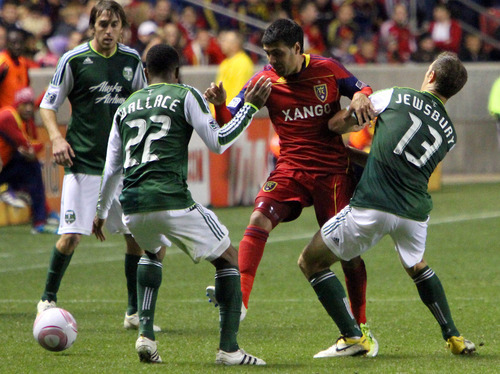 Stephen Holt/ Special to the Tribune
Real Salt Lakemidfielder Javier Morales is held back by Portland Timbers defender Rodney Wallace, left, and midfielder Jack Jewsbury during their 1-1 tie at Rio Tinto Stadium in Sandy.