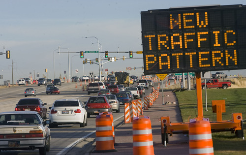Al Hartmann  |  The Salt Lake Tribune
Sign warns cars approaching SR 201 on northbound Bangerter Highway of the new diverging diamond interchange that opened late Sunday. Early reports said there were no accidents and a smooth flow through the area.