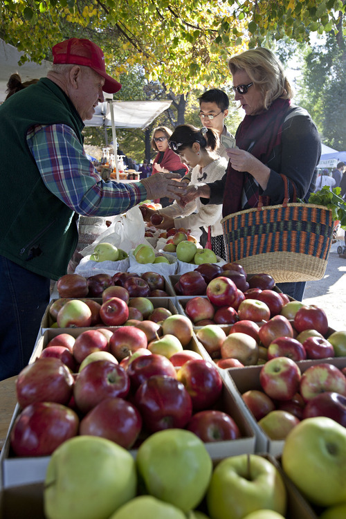 Lennie Mahler  |  The Salt Lake Tribune
Sherman Bennett of S&R Fruit sells apples to Gina Hiatt on the final day of the Downtown Farmers Market in Salt Lake City on Saturday, Oct. 22, 2011.