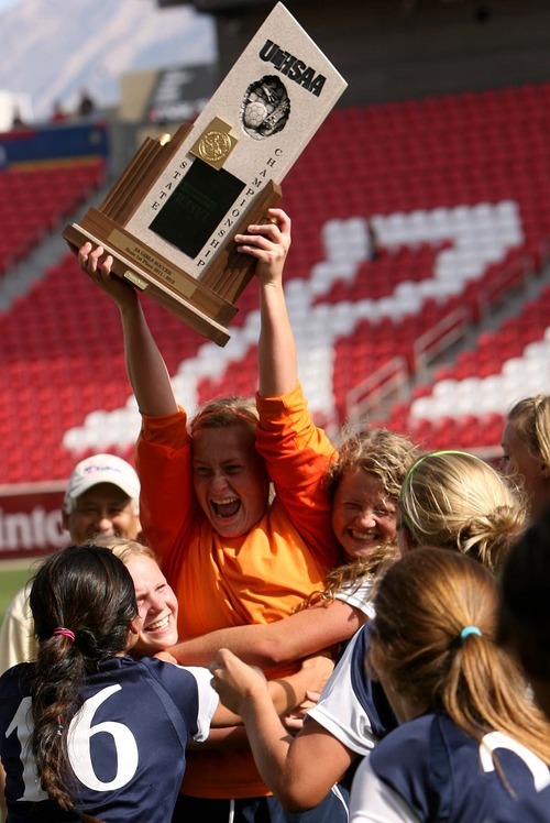 Leah Hogsten | The Salt Lake Tribune 
Waterford  goalie Jeannie Woller raises the state trophy for the team. Waterford High School defeated St. Joseph High School 1-0 to seize the 2A State Girls Soccer Championship titlle Saturday,October 22 2011 at Rio Tinto Stadium.