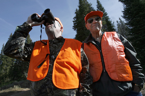 Francisco Kjolseth  |  The Salt Lake Tribune
Dennis Adams of Payson uses his binoculars to look for deer in the Soapstone Basin area in the Uinta Mountains along with his dad Wayne, 81, of Orem on Saturday. The general season deer hunt opened Saturday at dawn. It is Utah's biggest hunt with more than 65,000 hunters pursuing mule deer on the last year the state will be divided into five regions. Next year it will be 30 units, which will limit hunters to a much smaller area they can search for deer.