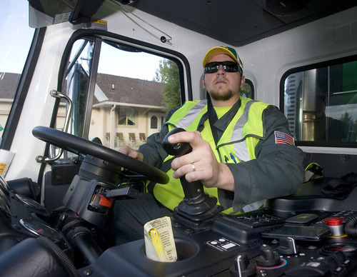 Al Hartmann  |  The Salt Lake Tribune

Dustin Marcek, a driver for Waste Management, is collecting garbage in a truck that runs on compressed natural gas, which reduces emissions.