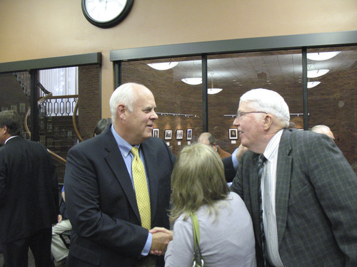 Donald W. Meyers  |  The Salt Lake Tribune
Newly selected Orem Mayor James T. Evans, left, is congratulated by former state Rep. Norman Nielsen Monday after Evan's selection to fill the remainder of Mayor Jerry Washburn's term. The woman in the middle is Tana Evans, Evans' wife.