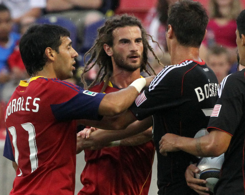 Rick Egan  |  The Salt Lake Tribune

Kyle Beckerman gets a shove from Branko Boskovic from D.C. United as Real Salt Lakes Javier Morales steps during their match at Rio Tinto Stadium on Saturday.