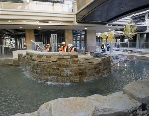 Al Hartmann   |  The Salt Lake Tribune 
Workers contine construction on one of several water features in the  City Creek Center on  Wednesday, Oct. 26. The new shopping and dining destination will transform downtown Salt Lake City with its mix of modern architecture, historic restoration and restored creek. It is opening March 22.