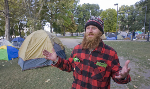 Al Hartmann  |  The Salt Lake Tribune
Braden Jordan greets a cold Thursday morning at the Occupy Salt Lake camp in Pioneer Park.   He has been camped there for two weeks.
