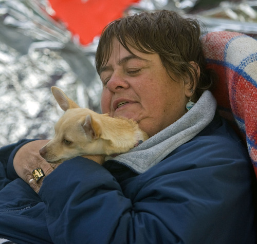 Al Hartmann  |  The Salt Lake Tribune
Cynthia Cook, who is in a wheelchair, tucks her friend's dog 