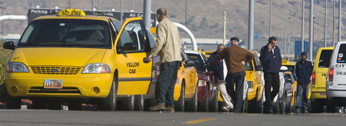 Al Hartmann  |  The Salt Lake Tribune
Taxi cab drivers wait for fares south of the Salt Lake City International Airport on Thursday. Two local cab companies were passed over for contracting for on-demand services to two out-of-state firms.