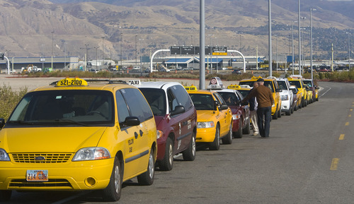 Al Hartmann  |  The Salt Lake Tribune
Taxi cab drivers que up for fares south of the Salt Lake International Airport on Thursday October 27. Two  local cab companies were passed over for contracting for on-demand services to two out-of-state firms.