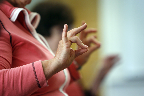 Francisco Kjolseth  |  The Salt Lake Tribune
Karen Teter, 70, of Holladay who suffers from arthritis, stretches her fingers as Margaret Crowell teaches her weekly P.A.C.E. (People with Arthritis can Exercise) class at the Mt. Olympus Senior Center.