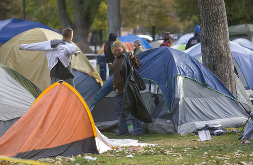 Al Hartmann  |  The Salt Lake Tribune
The sun rises over the Occupy Salt Lake City camp in Pioneer Park about 8:30 a.m. Thursday, Oct. 27 and campers emerge from tents and wrap up in warm clothes.   It was one of the coldest nights of the season.