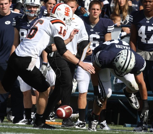 Rick Egan  | The Salt Lake Tribune 

Idaho State Bengals punter David Harrington (16) tries to grab a blocked punt along with Brigham Young Cougars linebacker Jameson Frazier (48), in football action,  BYU vs. Idaho State University football game, at Lavell Edwards Stadium, Saturday, October 22, 2011.