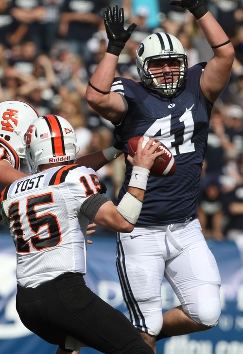 Rick Egan  | The Salt Lake Tribune 

Idaho State Bengals quarterback Kevin Yost (15) looks to pass, as  Brigham Young Cougars defensive lineman Matt Putnam (41)puts on the pressure, in football action,  BYU vs. Idaho State University football game, at Lavell Edwards Stadium, Saturday, October 22, 2011.