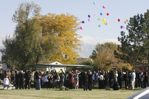 Rick Egan  | The Salt Lake Tribune 
 
Balloons are released at the grave side service for 16-year-old Alexis Rasmussen, at Valley View Memorial Park, in West Valley, Saturday, October 29, 2011.