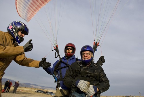 Djamila Grossman  |  The Salt Lake Tribune

Joe Herring, a Navy veteran, and pilot Jonathan Jefferies get a thumbs-up as they get ready to paraglide at South Side Flight Park, Point of the Mountain in Draper, Utah, on Saturday, Oct. 29, 2011. Davis and other veterans paired up with pilots of the Utah Hang Gliding and Paragliding Association to fly.