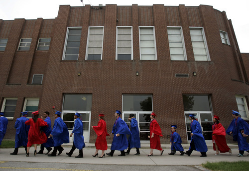 Tribune file photo
Cap-and-gowned members of the final senior class at Granite High School march pass the building, which could become a South Salt Lake city community center if residents vote Nov. 8 for a $25 million bond to purchase the buildings and 27 surrounding acres.