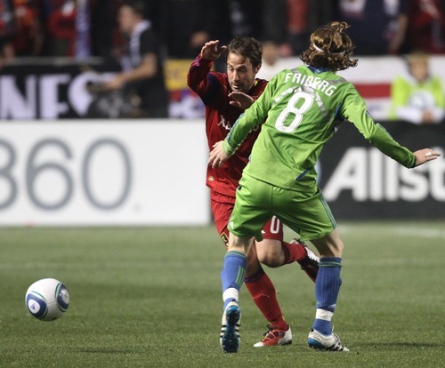 Rick Egan  | The Salt Lake Tribune 

Seattle Sounders defender Zach Scott (20),  stops Seattle Sounders defender Zach Scott (20) as he goes for the ball, in MLS soccer action, Real Salt Lake vs. the Seattle Sounders, in Sandy, Saturday, October 29, 2011Saturday, October 29, 2011. Friberg (8), was given a yellow card on the play.