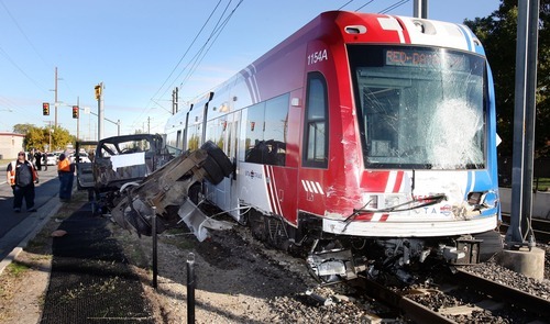 Steve Griffin  |  The Salt Lake Tribune
A derailed TRAX train sits near the intersection of 6100 south and 300 west in Murray on Monday after hitting a truck. The Utah Transit Authority has received complaints about crossing guard arms at the intersection staying down far longer than needed.