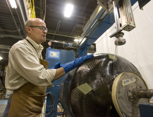 Al Hartmann  |  The Salt Lake Tribune 
Quentin Barney, winder technician, works on a waste tank container for a jetliner that is being wrapped in carbon fiber at the ITT Exelis carbon -composite manufacturing facility at the International Center in Salt Lake City.