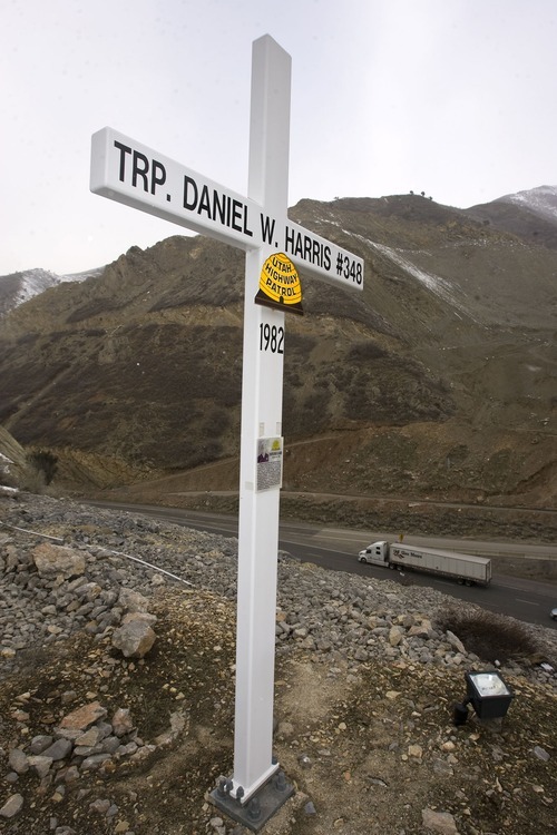 A cross along Interstate 80 about up Parleys Canyon memorializes Trooper Dan Harris, who died there in 1982 while chasing a speeder.   The cross is set above the roadway about 2 miles up the canyon.   Al Hartmann/The Salt Lake Tribune     3/9/09