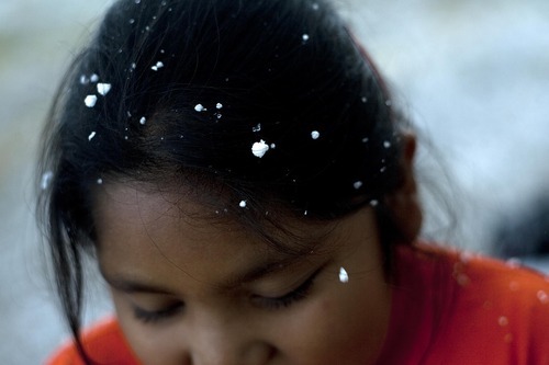 Djamila Grossman | The Salt Lake Tribune

LaRae Bishop-Moon plays in the first snow, at her family's home in Ibapah, Utah, on Thursday, Oct. 6, 2011.