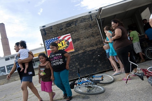 Djamila Grossman | The Salt Lake Tribune

Tarina Bishop stands in line for fireworks as she watches her daughters Raenee Bishop-Moon and niece LaRae Bishop-Moon walk off with Twila Jim during 4th of July festivities in Wendover, Utah, on Monday, July 4, 2011.