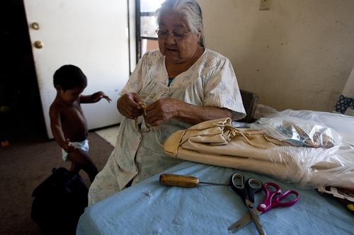 Djamila Grossman | The Salt Lake Tribune

Orlena McCurdy works on a cradleboard as her great-grandson Adrian Villarreal walks around at their home in Ibapah, Utah, on Saturday, Aug. 6, 2011.